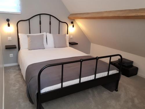 a bedroom with a large bed with white pillows at Les Deux Lacs - Stunning Gite, with private swimming pool and 2.75 acre fishing lake in La Chapelle-Verlaine