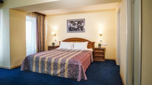 a hotel room with a bed and a window at Marins Park Hotel Novosibirsk in Novosibirsk