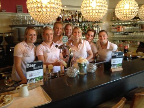 a group of women standing behind a bar at Bed & Breakfast De Vier Seizoenen in Lisse