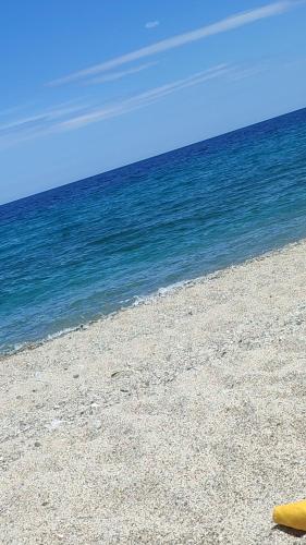 a beach with a yellow surfboard on top of it at B&B Nonna Antonietta in Sibari