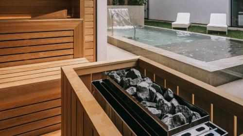 a jacuzzi tub in a house with two white chairs at Mangia's Torre Del Barone Resort & SPA in Sciacca