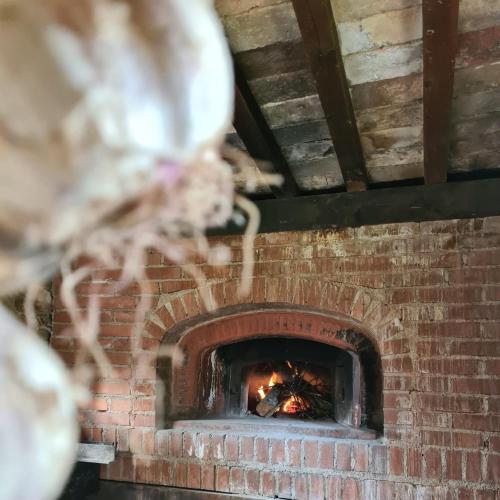 a brick oven with a fire in it at "il Casaletto" Agriturismo Moderno, Vista Panoramica e Cibo Spettacolare- Scurcola Marsicana in Scurcola Marsicana