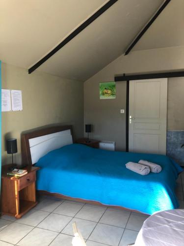 a bedroom with a blue bed in a room at Les Aubepines in La Plaine des Palmistes