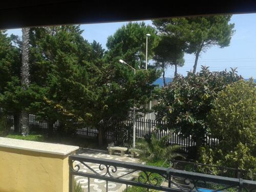 a view from a balcony with a fence and trees at Villa Midolo in Noto Marina