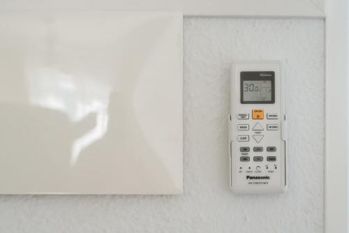 a calculator is attached to a wall at Villas New Lanzasuites in Playa Blanca