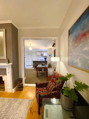 a living room with a couch and a table at Loose Leaf Cottage in Kyneton