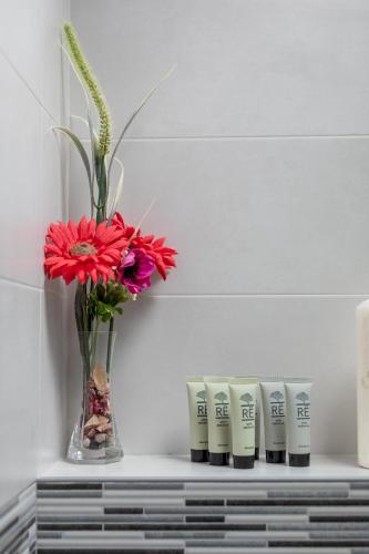 a shelf with a vase with a flower and a vase at Zumaiako Txapitula - BasKey rentals in Zumaia