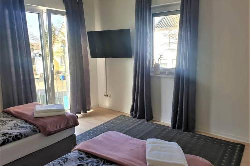 a bedroom with two beds and a large window at Ferienhaus mit Terrasse - Wallbox in Bad Oeynhausen