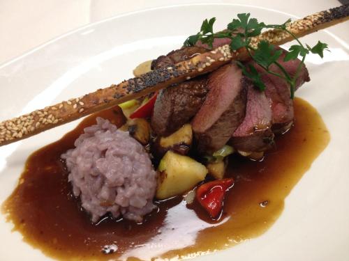 a plate of food with meat and rice and chopsticks at Bed & Breakfast De Vier Seizoenen in Lisse