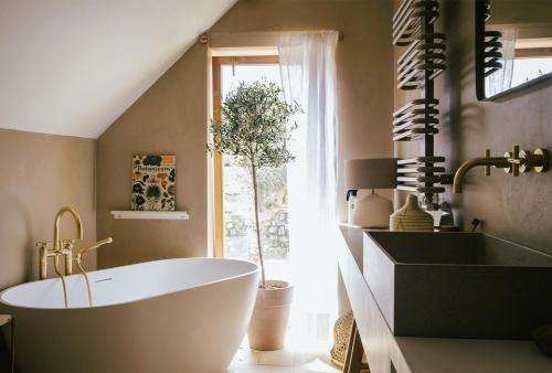 a bathroom with a white tub and a window at Marináda Viniční dům in Pavlov