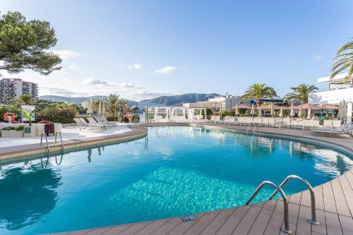 a large pool with blue water in a resort at FERGUS Style Tobago - Adults Only in Palmanova