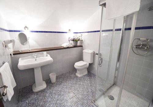 a bathroom with a toilet and a sink and a shower at Batzarki in Avellaneda
