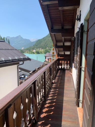 a balcony of a building with a view of a lake at Tizzi Home in Alleghe