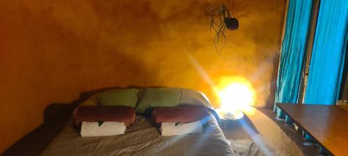 a bed with pillows on it in a room at Associação Quinta das Relvas in Branca