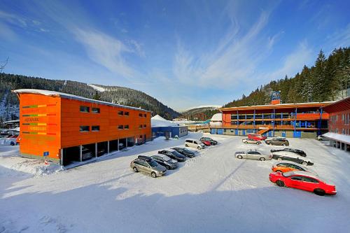 a group of cars parked in a parking lot in the snow at Resort Špindl in Špindlerův Mlýn