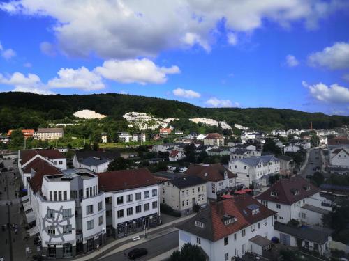 a city with buildings and a mountain in the background at Rügen-Hotel in Sassnitz