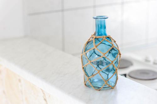 a blue glass bottle sitting on top of a counter at Apartman More in Šibenik
