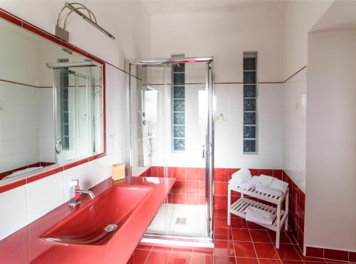 a bathroom with a red sink and a shower at Borgo Rio in Rionero Sannitico