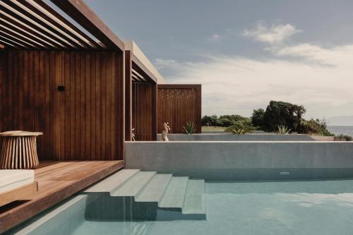 a house with a swimming pool next to the ocean at Meraviglia Slow Living in Preveza