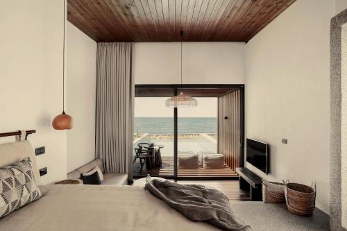 a bedroom with a bed and a view of the ocean at Meraviglia Slow Living in Preveza