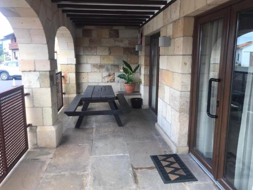 a patio with a picnic table on a building at Casa el Elefante Blanco in Cabarceno