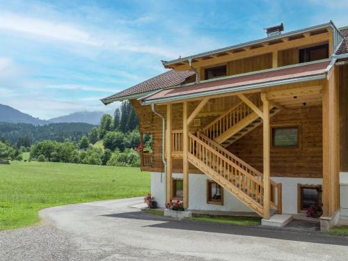 a large wooden house with a staircase on it at Bauernhof Unterstegen in Söll