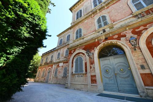 an old brick building with a blue door on it at Hotel Iris in Perugia