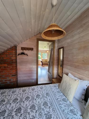a bedroom with a bed and a ceiling at Rasos Vila in Palanga