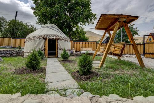 a yurt in a yard with a wooden fence at Guest House NAUKA#54 in Bishkek