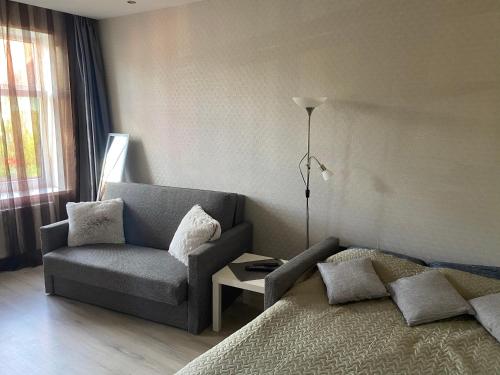 a living room with a couch and a chair at Karla iela in Ventspils
