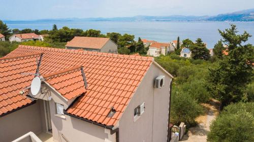 a house with an orange roof with a view of the water at Villa Tereza in Splitska