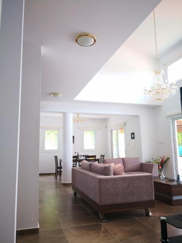 a living room with a couch and a table at Villa14 Sea Breeze in Khlorakas