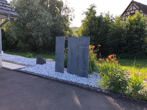 a sculpture in the middle of a garden at Havre de paix dans le Jura Alsacien avec piscine privée externe de mai à septembre in Bendorf
