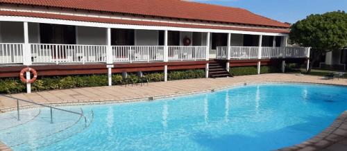 a large swimming pool in front of a building at Sand Dollar @ The Dunes in Plettenberg Bay