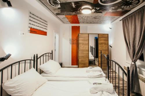 a group of four beds in a room at Sarajevo Stories Apartments Free Parking in Sarajevo