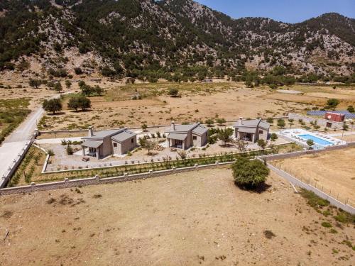 an aerial view of a house in a field at Omalos Village in Omalós