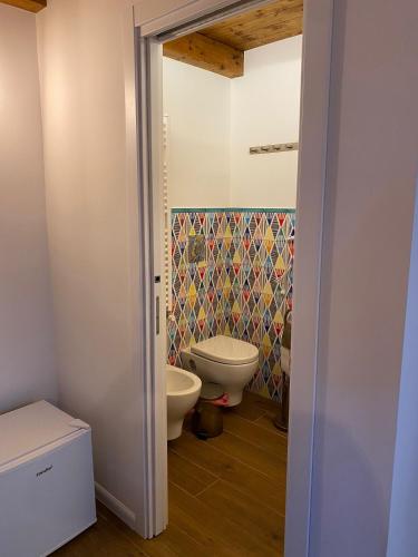 a bathroom with a toilet and a bidet at B&B Vietri Centro in Vietri sul Mare