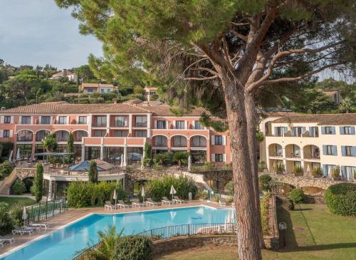a view of the resort with a pool and trees at Hôtel Les Jardins De Sainte-Maxime in Sainte-Maxime