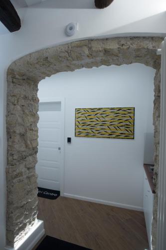 a room with a stone wall and a painting on the wall at B&B Vietri Centro in Vietri sul Mare