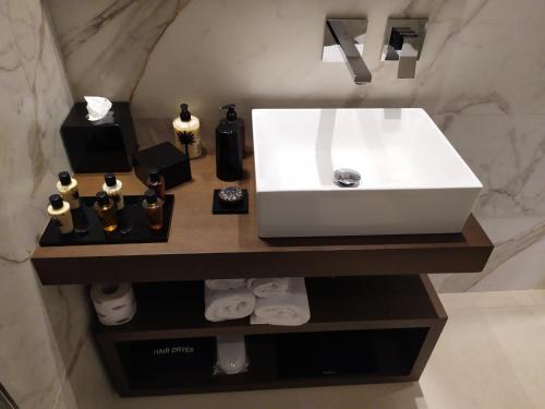 a bathroom with a white sink on a counter at Palazzo Salomone in Siracusa