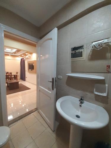 a bathroom with a white sink and a toilet at SARAYA AWAD HEGAZI STREET- families only in Alexandria