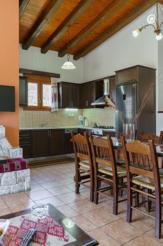 a kitchen and dining room with a table and chairs at Omalos Village in Omalós