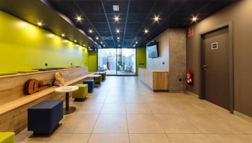 a waiting room with yellow and green walls at ibis budget Huerta De Murcia in Murcia