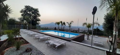 una piscina con tumbonas blancas en Villa Mola Bed And Breakfast, en Corbara