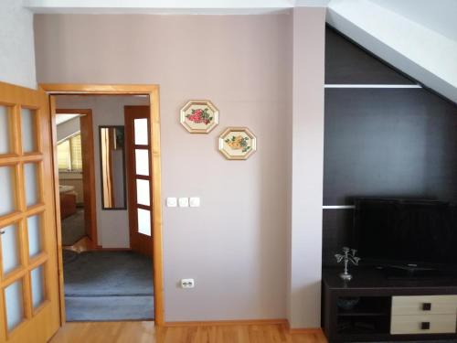 a living room with a tv and a hallway at Luxury Apartment Biljana in Ohrid