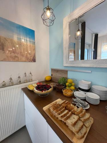 a kitchen with bread and other foods on a counter at Venezia De Luxe Dom Wypoczynkowy in Łeba