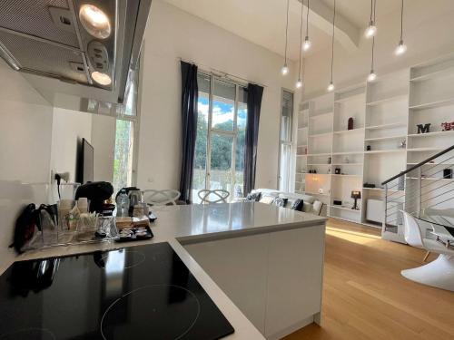 a kitchen with a large island in a room at Loft Milano Manifatture in Milan