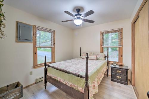 a bedroom with a bed and a ceiling fan at Riverfront Escape with Dock 19 Mi to Saratoga! in Lake Luzerne