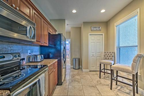 a kitchen with a stove top oven next to a window at Bright Bayfront Home Less Than 2 Mi to Hernando Beach! in Hernando Beach