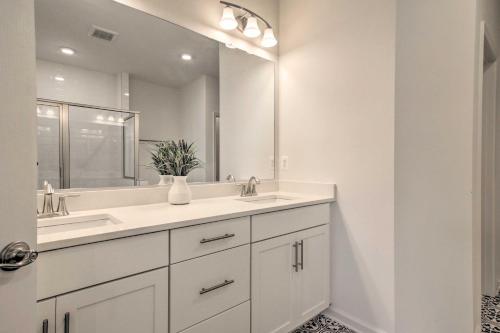 a bathroom with two sinks and a large mirror at Bright Bishops Landing Home Less Than 5 Miles to Beach! in Millville